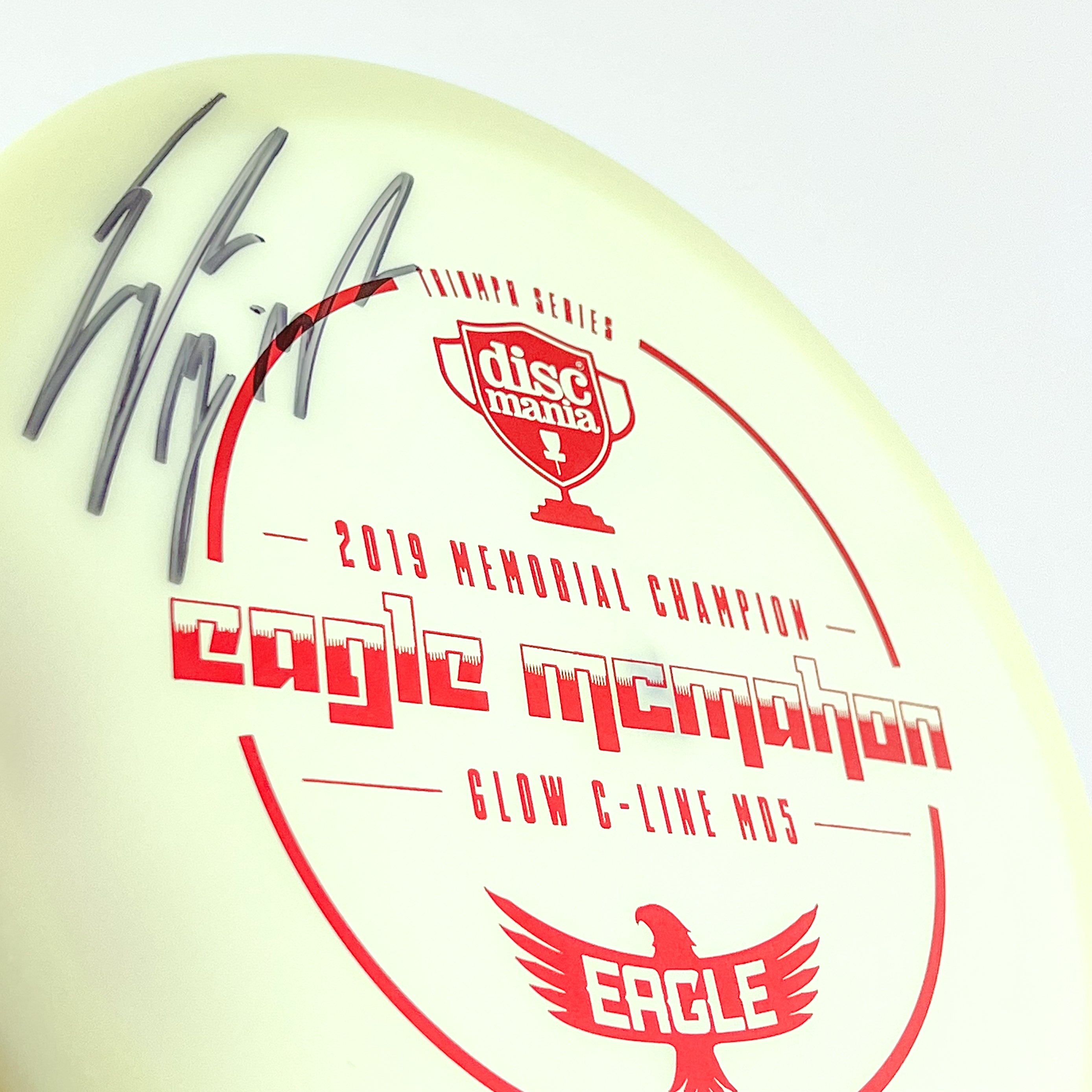 Eagle McMahon signed glow MD5 disc golf midrange disc by Discmania Golf Discs.